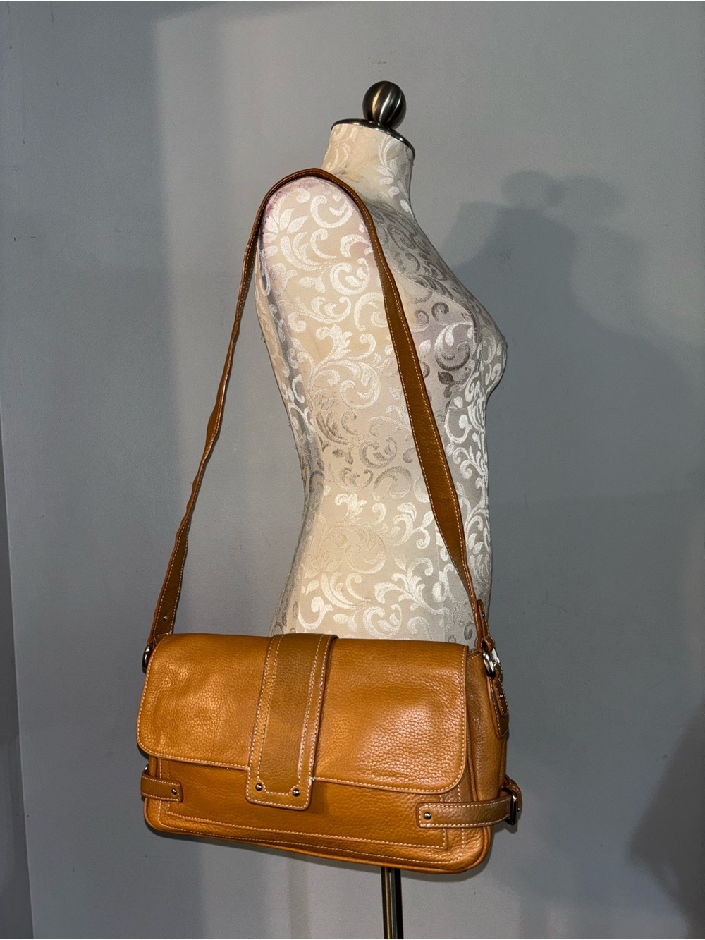 Tignanello pebbled leather shoulder bag rendered in a rich tan/cognac shade.